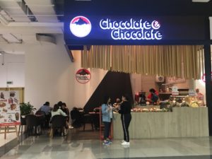 2 girls in front of chocolate store